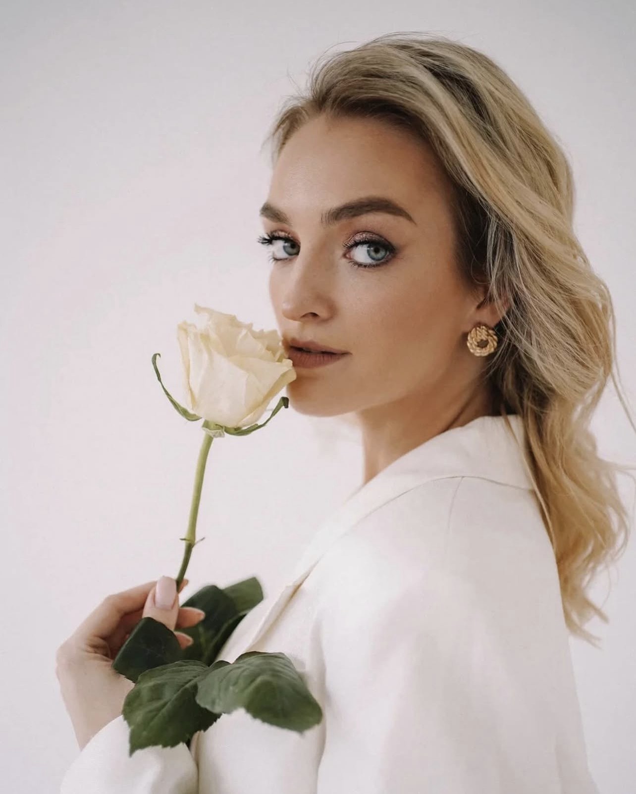 Olga holding a white rose